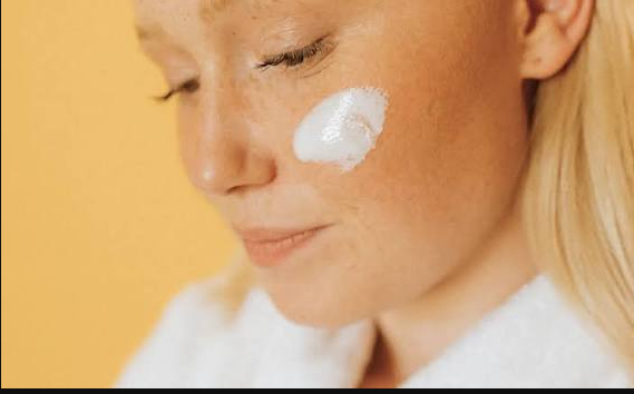 Woman applying skincare on her face